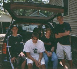 A group shot in front of the soccer mom van